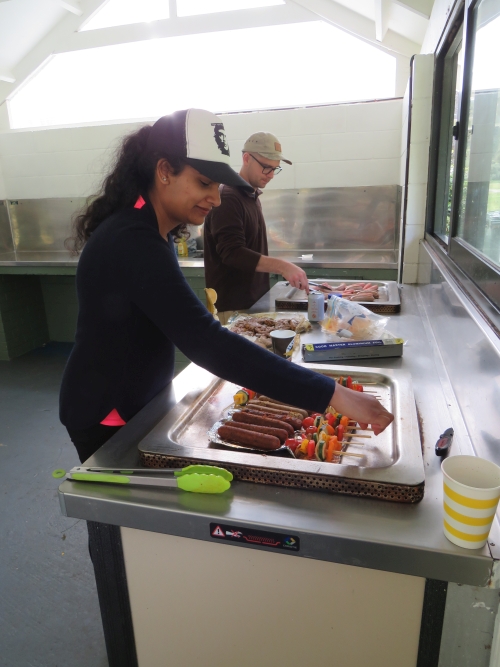 ACC volunteers cooking BBQ lunch in the campground kitchen during their volunteer day at the Catchpool. 