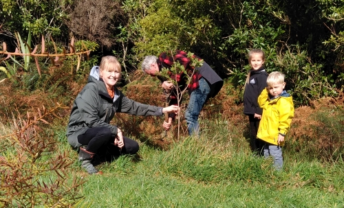 Photo of family planting trees during Conservation Week in the Remutaka Forest Park